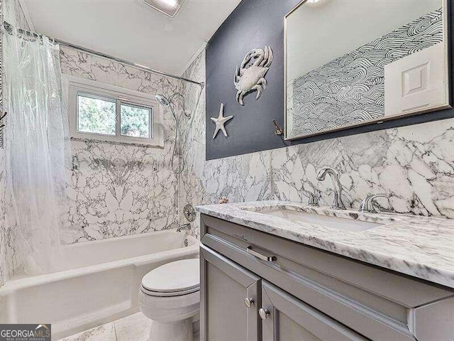 full bathroom with tile walls, shower / tub combo with curtain, vanity, and toilet