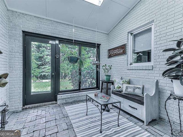 sunroom / solarium featuring vaulted ceiling