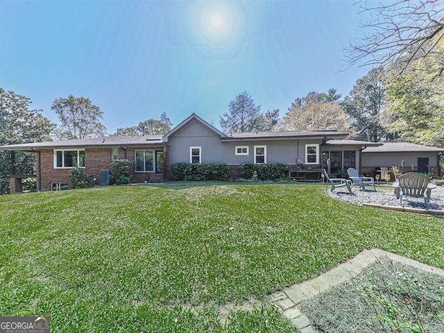 rear view of property featuring a lawn