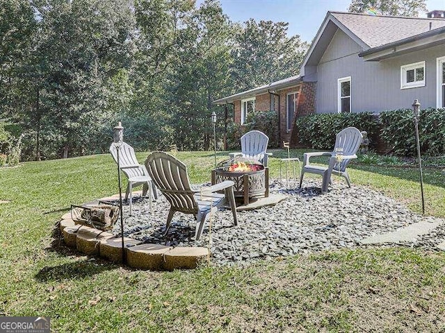 view of yard with an outdoor fire pit