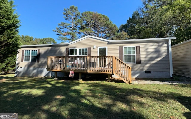 back of property featuring a deck and a yard