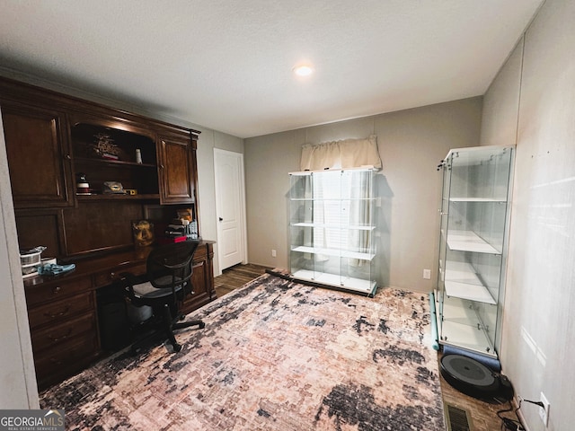 home office with dark hardwood / wood-style flooring