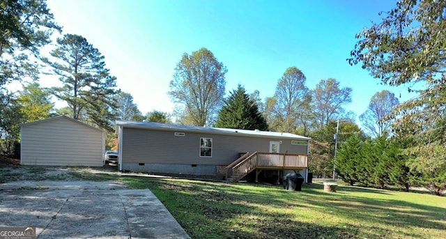 rear view of property featuring a wooden deck and a yard