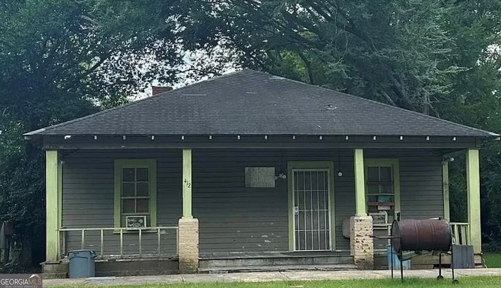 back of house featuring covered porch