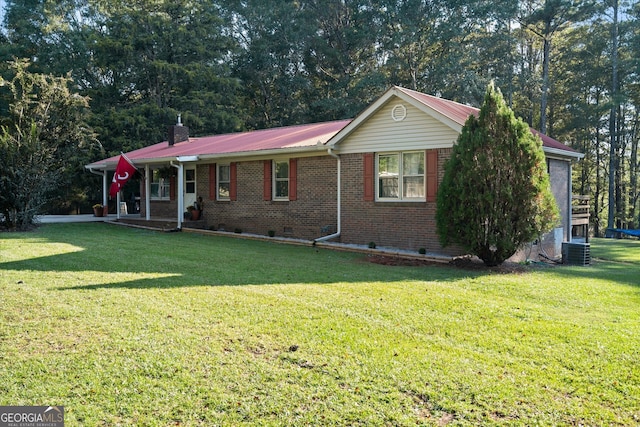 ranch-style house featuring cooling unit and a front lawn