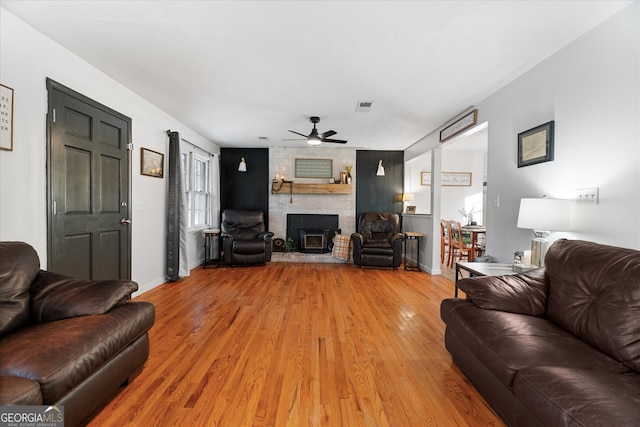 living room featuring wood-type flooring and ceiling fan