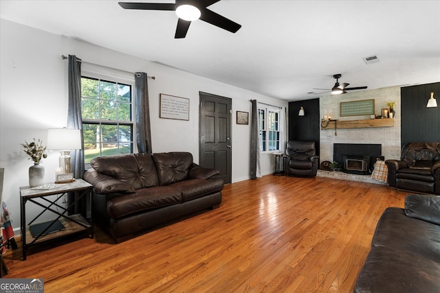 living room with hardwood / wood-style floors and ceiling fan