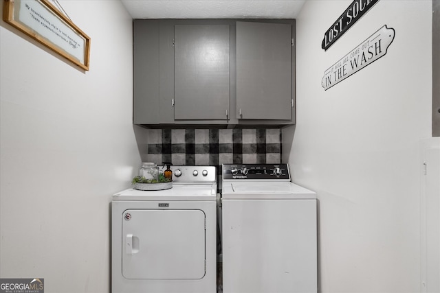 washroom featuring cabinets and washer and dryer