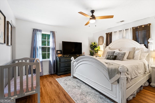 bedroom with ceiling fan and light hardwood / wood-style flooring