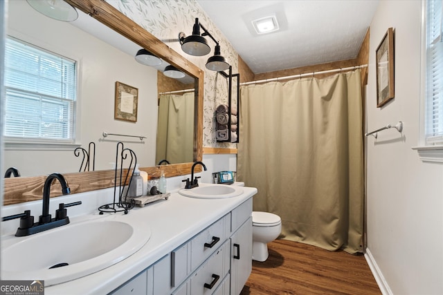 bathroom featuring a shower with shower curtain, vanity, toilet, and hardwood / wood-style flooring