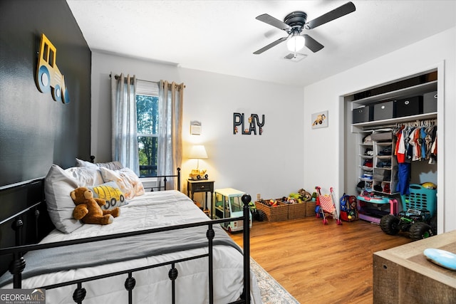 bedroom featuring a closet, wood-type flooring, and ceiling fan