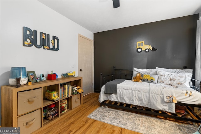 bedroom featuring wood-type flooring and ceiling fan