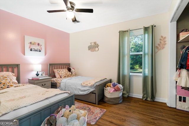 bedroom featuring ceiling fan and dark wood-type flooring