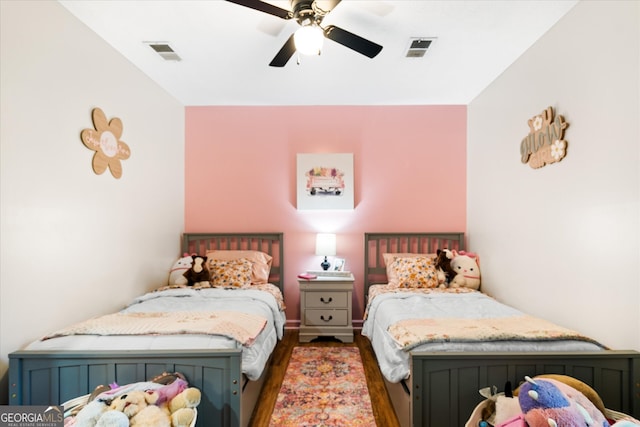 bedroom with ceiling fan and dark hardwood / wood-style floors