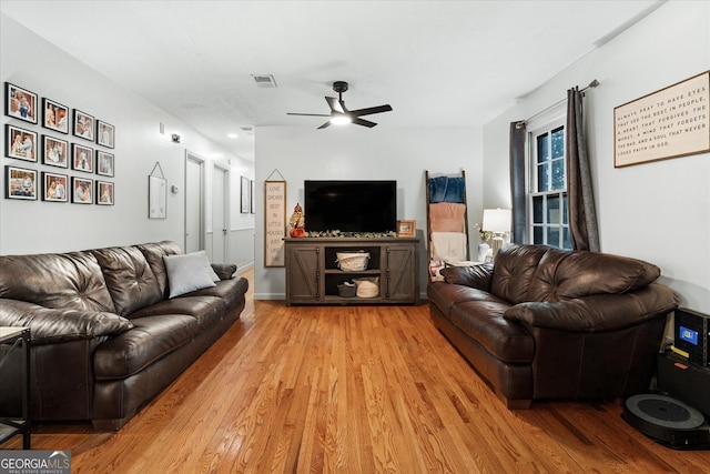 living room featuring light wood-type flooring and ceiling fan