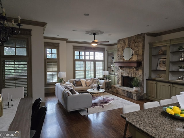 unfurnished living room with a wealth of natural light, a notable chandelier, a fireplace, and dark wood-type flooring