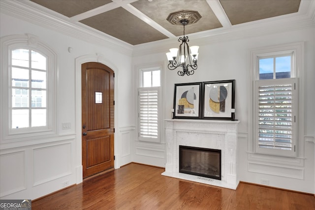 foyer featuring coffered ceiling, hardwood / wood-style flooring, and plenty of natural light