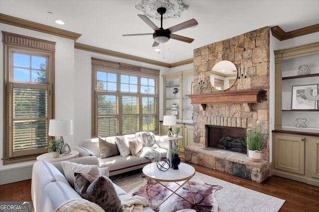 living room featuring ornamental molding, dark hardwood / wood-style flooring, and a wealth of natural light