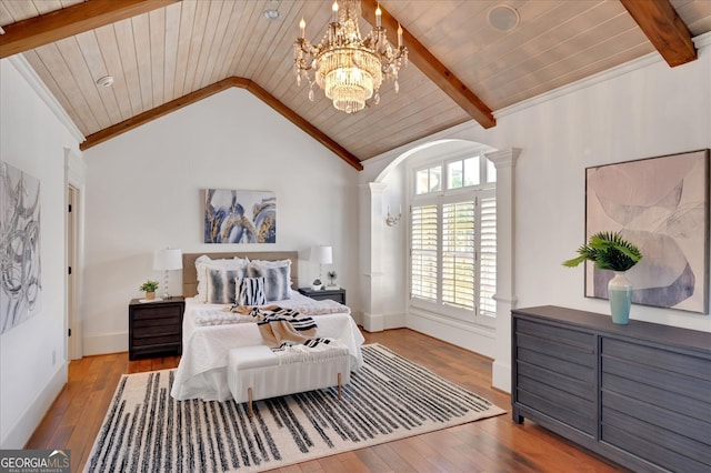 bedroom with vaulted ceiling with beams, light hardwood / wood-style floors, and wooden ceiling