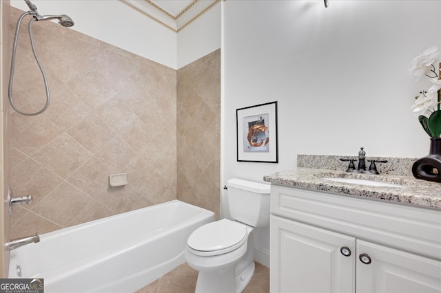 full bathroom featuring tile patterned flooring, tiled shower / bath, vanity, and toilet