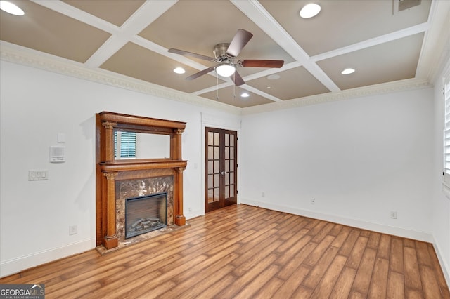 unfurnished living room with coffered ceiling, light wood-type flooring, and ceiling fan