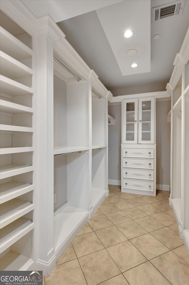 spacious closet with light tile patterned floors