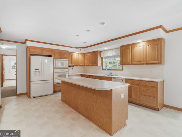 kitchen with tasteful backsplash, white appliances, sink, ornamental molding, and a center island