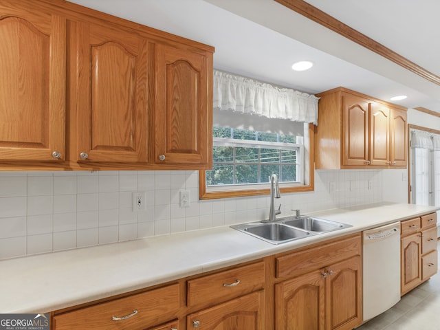 kitchen with light tile patterned flooring, tasteful backsplash, sink, dishwasher, and ornamental molding