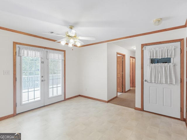 spare room featuring ceiling fan, ornamental molding, and french doors