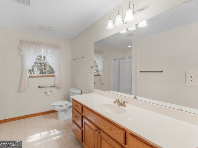 bathroom featuring vanity, walk in shower, and toilet