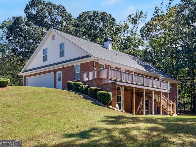 view of front of house featuring a garage, a front yard, and a wooden deck