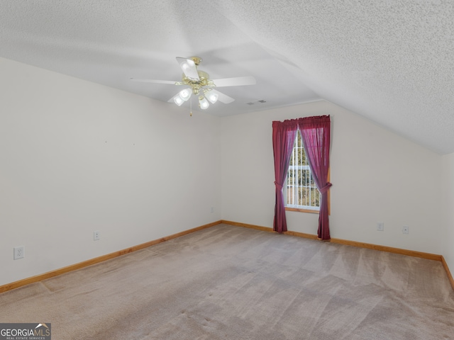 bonus room with light colored carpet, a textured ceiling, and lofted ceiling