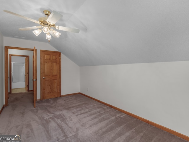 bonus room featuring light carpet, ceiling fan, and vaulted ceiling