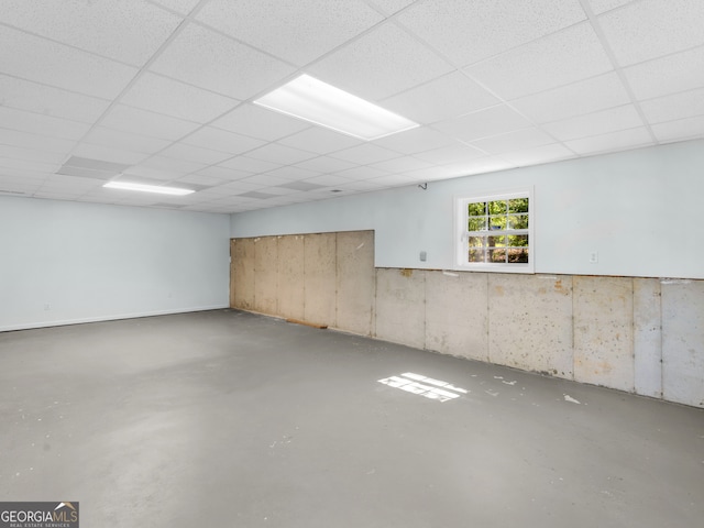 basement with a paneled ceiling