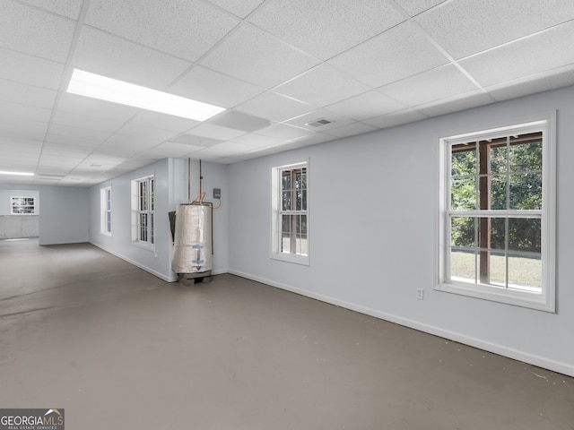 basement with gas water heater and a paneled ceiling