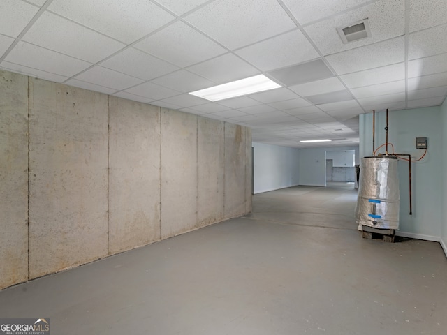 basement featuring gas water heater and a drop ceiling