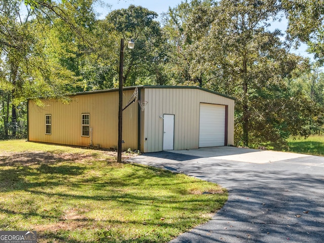 view of outbuilding featuring a yard and a garage