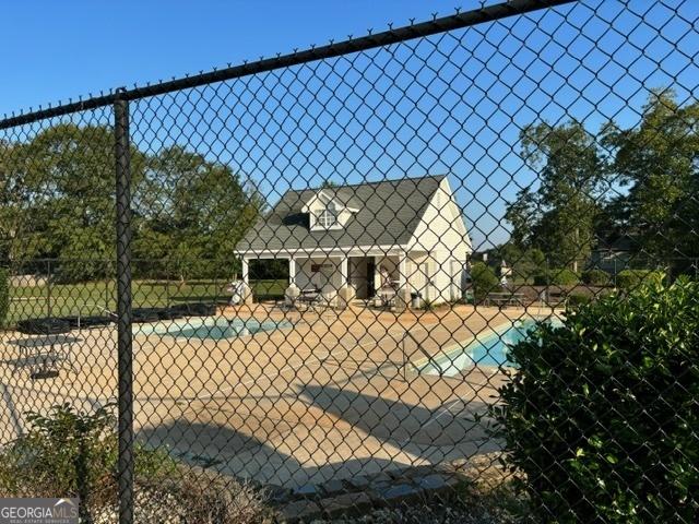 exterior space featuring a fenced in pool and a patio area