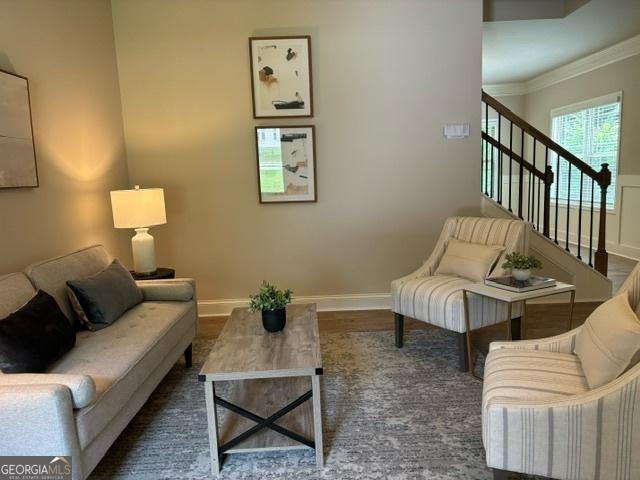 living room featuring crown molding and dark hardwood / wood-style flooring