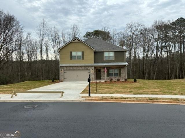 view of front facade featuring a front yard and a garage