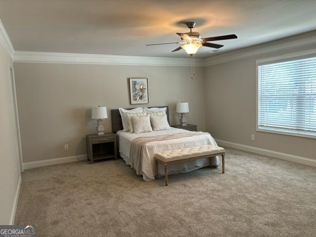 bedroom with ornamental molding, light carpet, and ceiling fan