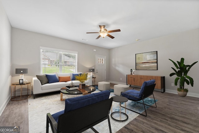 living room with ceiling fan and dark hardwood / wood-style floors