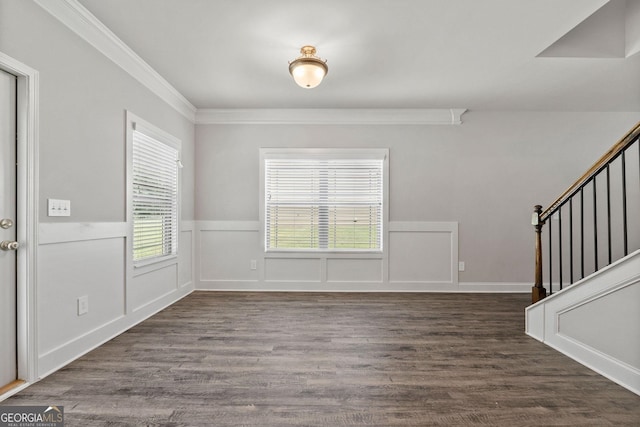 entryway with ornamental molding and dark hardwood / wood-style flooring