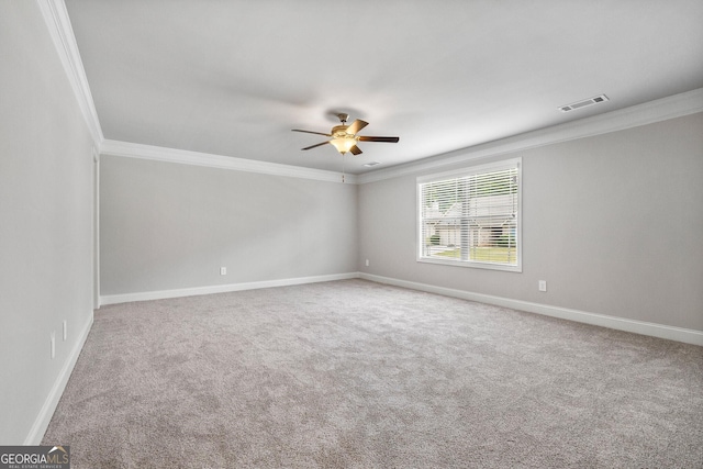 carpeted spare room featuring crown molding and ceiling fan