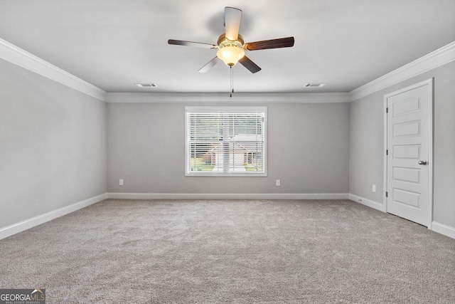 spare room featuring crown molding, ceiling fan, and carpet floors