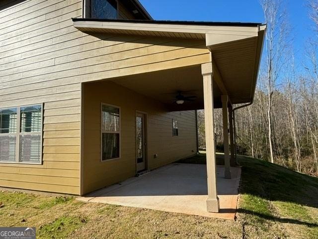 exterior space with ceiling fan and a patio area