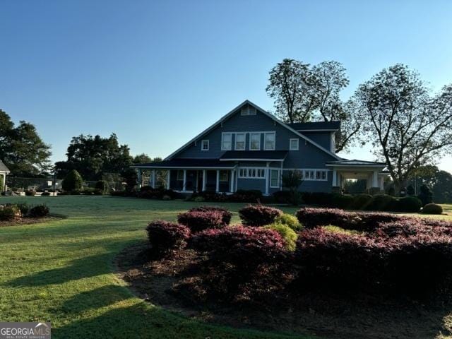 rear view of property with a lawn