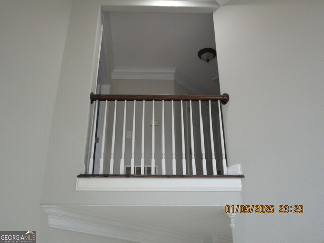 stairs featuring tile patterned flooring and ornamental molding