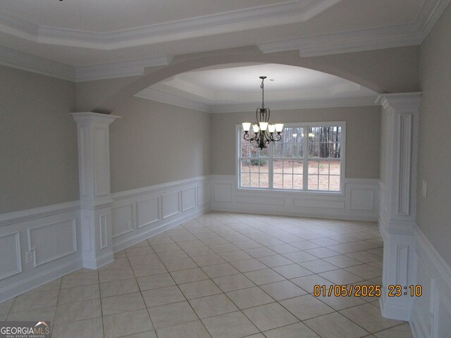 kitchen featuring black electric stovetop, a brick fireplace, island range hood, crown molding, and a center island