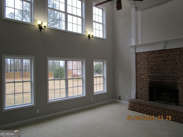 unfurnished dining area featuring light tile patterned flooring, decorative columns, a tray ceiling, and a chandelier